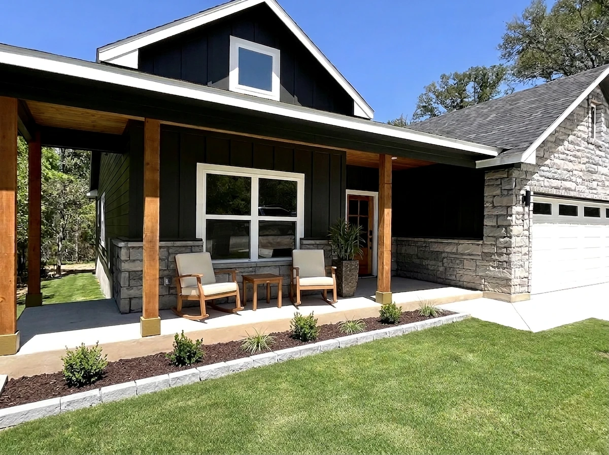 Craftsman style home with dark board and batten siding, stone wainscot, cedar posts and staged front porch